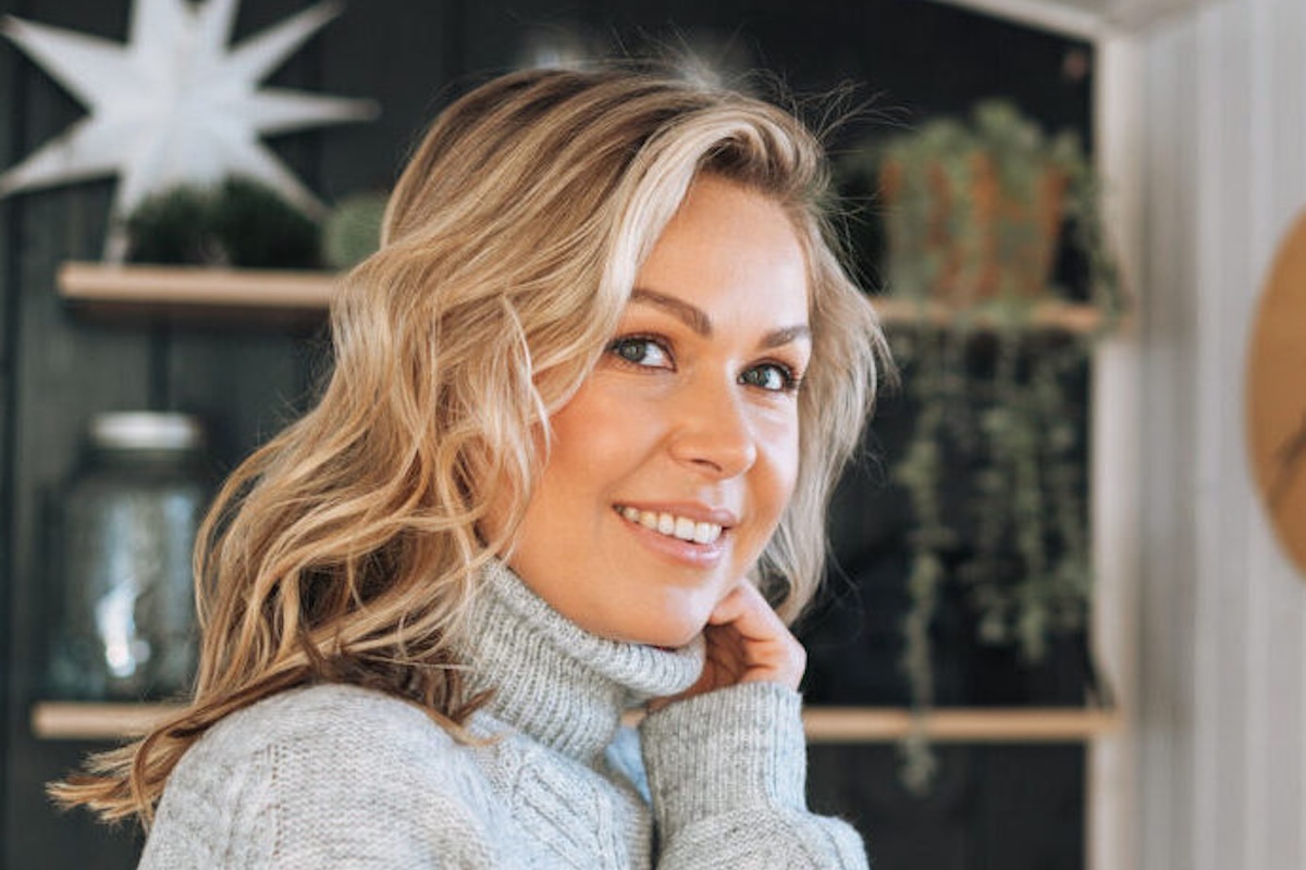 A woman in her study smiles