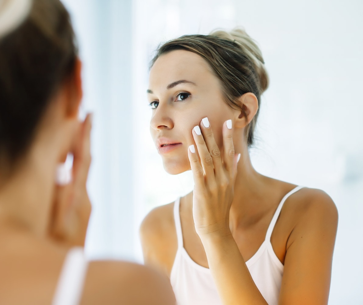 Laser Hybrid Woman looking in mirror