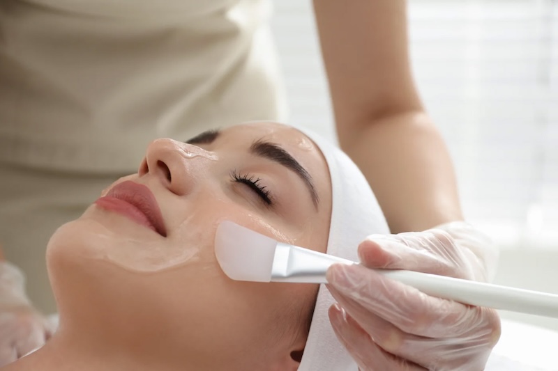 A woman receives a skin peel treatment