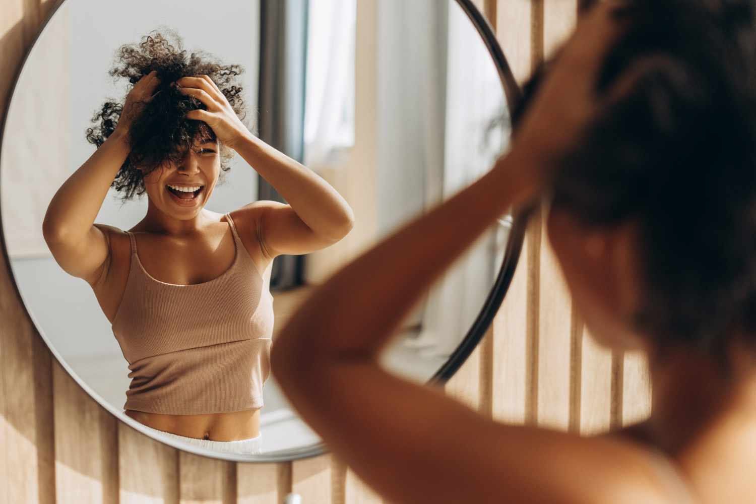 A woman admires herself in the mirror